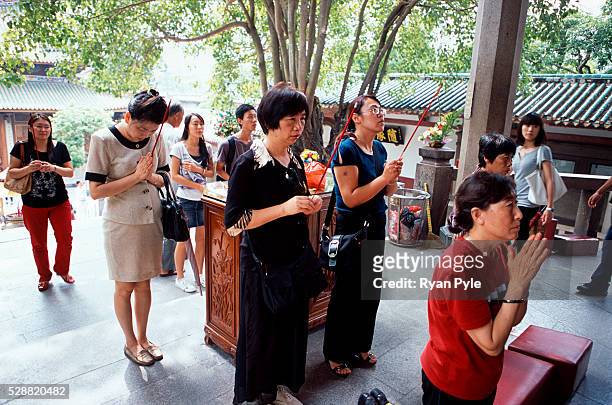 Visitors pray in front of the Hall of Great Benevolence at the Nanputuo Temple in Xiamen. The Nanputuo Temple is located on the southeast of Xiamen...