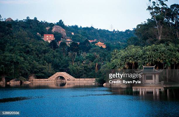 Small bridge on a lake inside the botanical garden near the Nanputuo Temple in Xiamen. The Nanputuo Temple is located on the southeast of Xiamen...