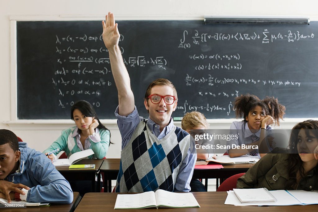 Nerdy student with hand raised