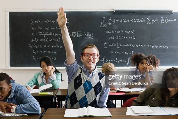 nerdy student with hand raised - geek 個照片及圖片檔