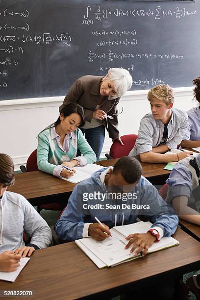 teacher and students in algebra class - archival classroom stock pictures, royalty-free photos & images