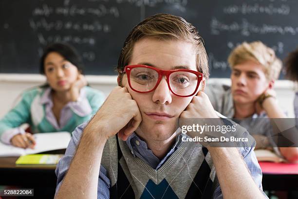 nerdy young man in classroom - nerdy guy stock pictures, royalty-free photos & images