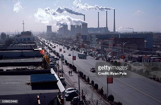 Coal-fired power plant spews smoke into the air in Daqi, Inner Mongolia, China. Baotou is an excellent example of a one-industry town, and that...
