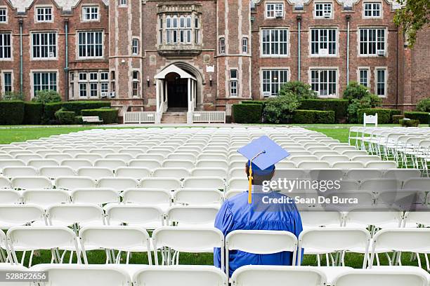 graduate sitting alone - university graduation stock pictures, royalty-free photos & images