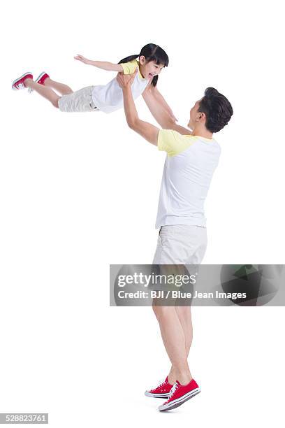 father lifting daughter overhead - airplane ride on toy stock pictures, royalty-free photos & images