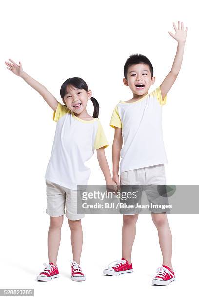 happy siblings - 手を挙げる ストックフォトと画像