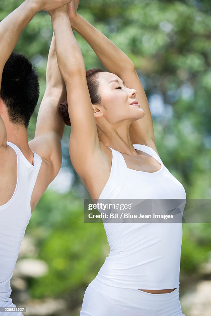 Young couple practicing yoga
