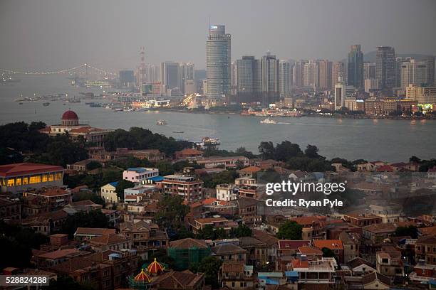 Looking out on Gulang Yu Island at dusk, with Xiamen City in the background. By the 1880s, Gulang Island was a colonial haven. It boasted its own...