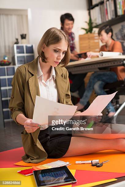 woman in design studio with sketches and tablet device - archival office stock pictures, royalty-free photos & images