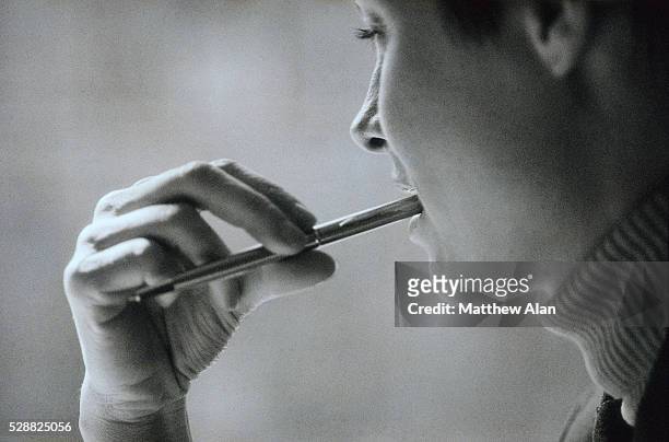 woman with pen in mouth - chewed stock pictures, royalty-free photos & images