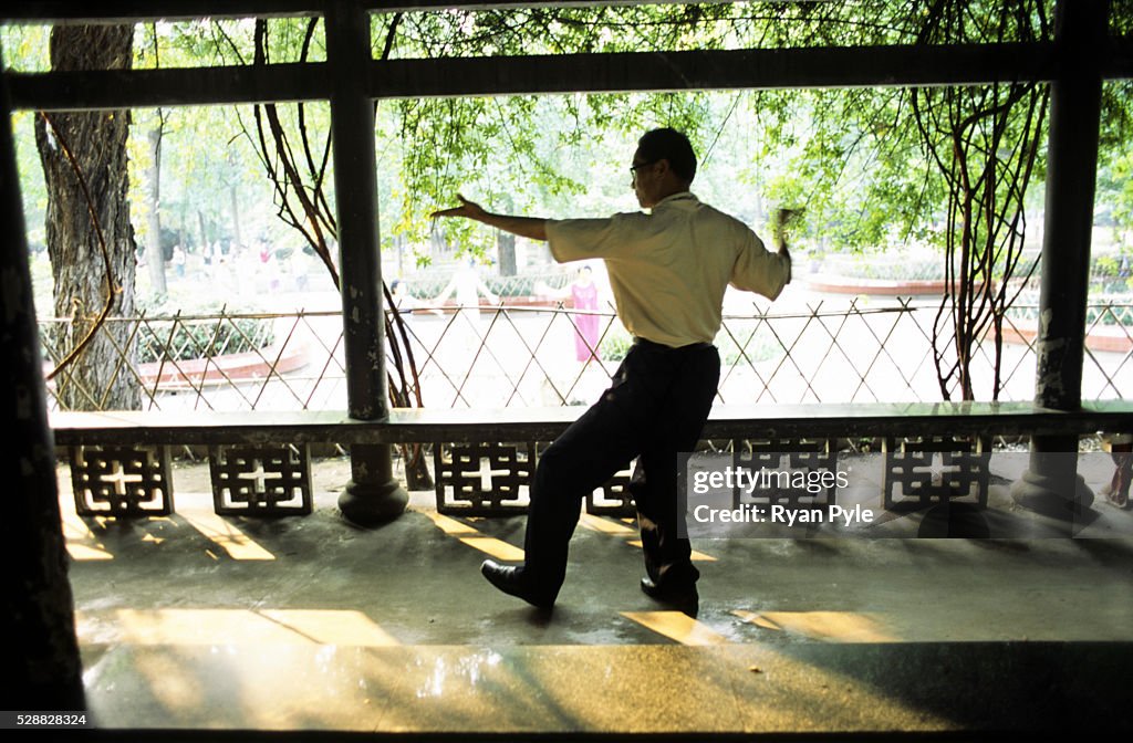 China - Chengdu - A Man Does Tai Chi in the Park