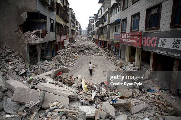 Young boy walks along a deserted street in Dujiangyan, Sichuan, China. A 7.9 magnitude earthquake that struck China's Sichuan province on Monday May...