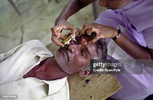 Patient gets treatment during an Aravind Outreach "Camp" program which extends eye care deep in to the India countryside, where often the need is...