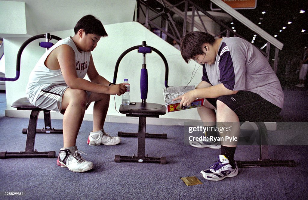 China - Health Issues - Tianjin - Obesity - Two Patients Read Magazines and Listen to Music