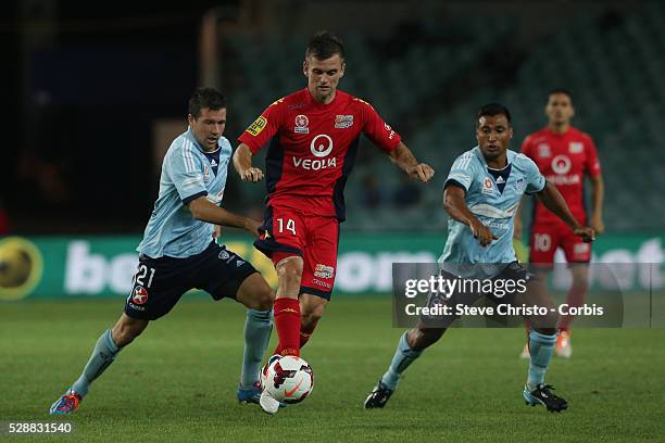 Adelaide's Cameron Watson battles for the ball with Sydney's Milos Dimitrijevic and Nick Carle during the match at Allianz Stadium. Sydney Australia....