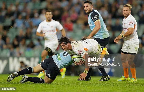 Francois Venter of the Cheetahs is tackled by Bernard Foley of the Waratahs during the round 11 Super Rugby match between the Waratahs and the...