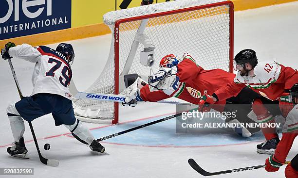 Slovakia's forward Libor Hudacek attacks Hungary's goalie Miklos Rajna during the group B preliminary round game Slovakia vs Hungary at the 2016 IIHF...