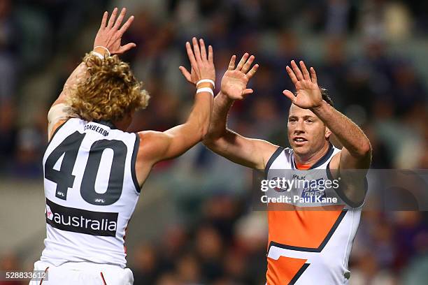 Adam Kennedy and Steve Johnson of the Giants celebrate a goal during the round seven AFL match between the Fremantle Dockers and the Greater Western...
