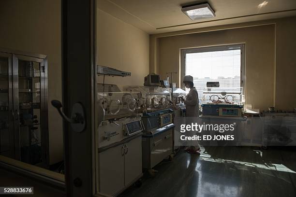 Nurse stands before incubators in a ward at the Pyongyang Maternity Hospital during a government-organised media tour in Pyongyang on May 7, 2016....