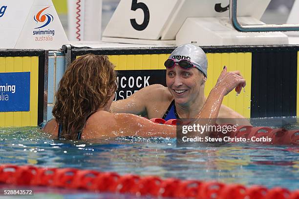 Sally Hunter hugs winner Jennie Johansson of Sweden after the Women's 50m Breaststroke final during the Hancock Prospecting Australian Swimming...