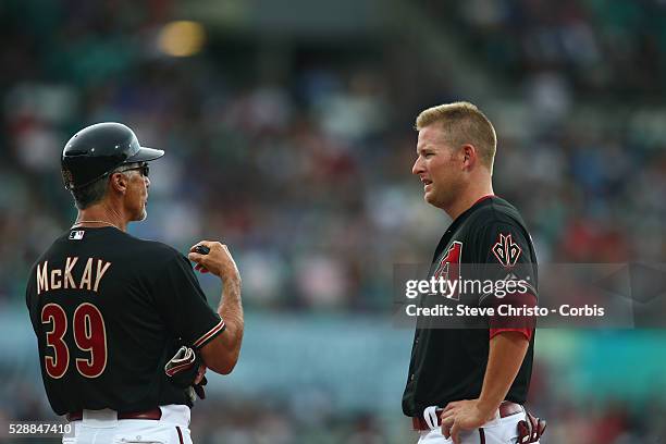 Arizona Diamondbacks Mark Trumbo talks to first base coach Dave Mackay during the match against the Los Angeles Dodgers at the Sydney Cricket Ground....