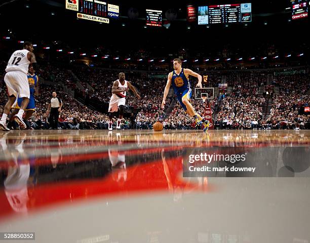 David Lee, a Golden State Warrior, dribbles down the court at a game versus the Portland Trail Blazers. The Trail Blazers won 90 to 87.