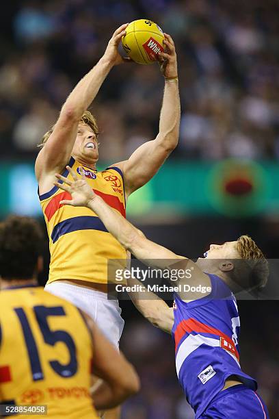 Rory Sloane of the Crows marks the ball against Lachie Hunter of the Bulldogs during the round seven AFL match between the Western Bulldogs and the...