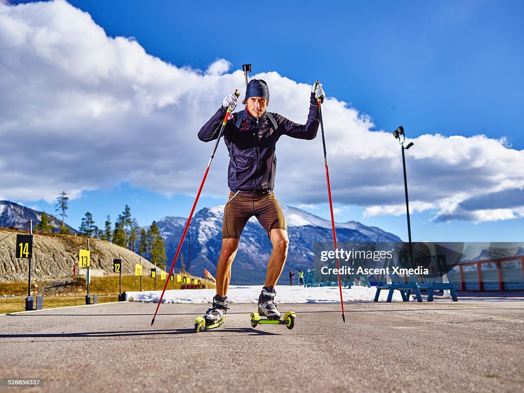 Biathlon athlete skiing with competition rifle