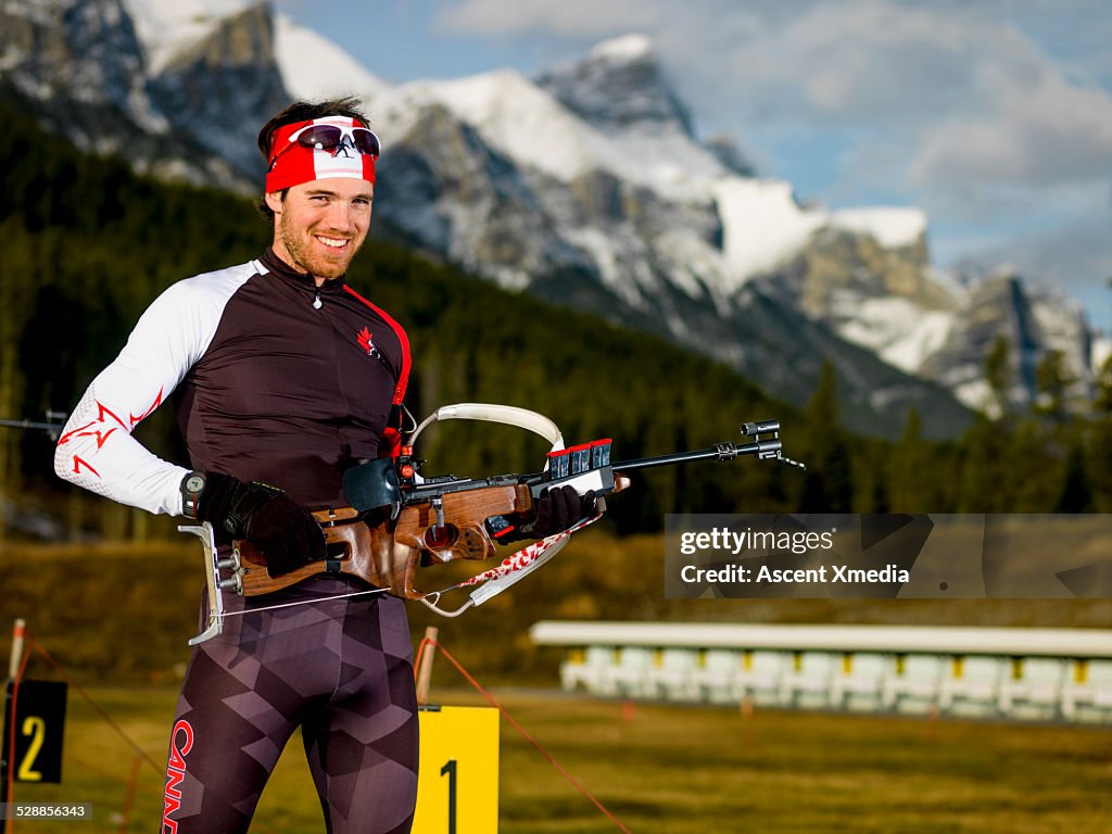 Biathlon athlete prepares, with competition rifle