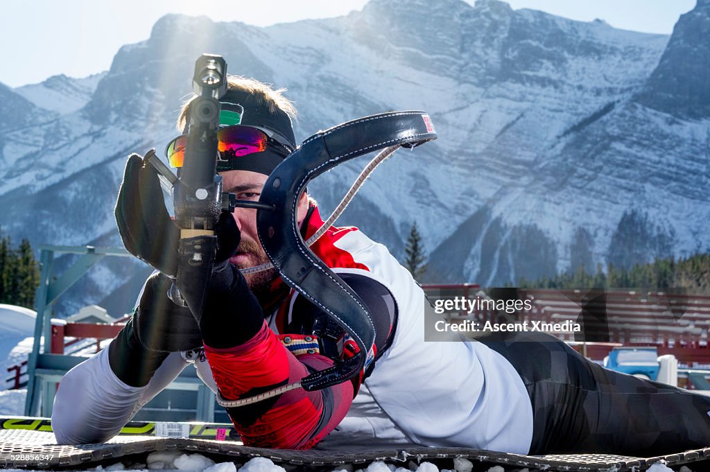Biathlon athlete takes aim with competition rifle