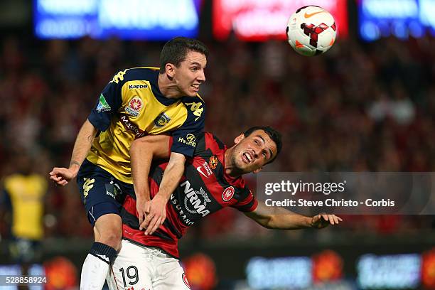 Wanderers Mark Bridge challenges Mariners Storm Roux for a header at Parramatta Stadium. Sydney, Australia. Saturday 26th April 2014.