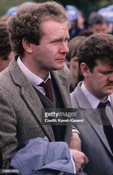 Sinn Fein's deputy leader and alleged IRA chief of staff, Martin McGuinness attends the funeral of an IRA volunteer, as officers of the Garda look...