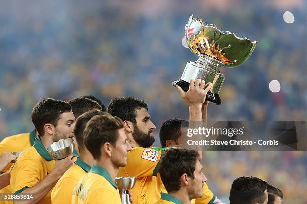 Reflections as Australia's captain Mile Jedinak holds up the Asian Cup after defeating Korea Republic 2-1 in extra time at Stadium Australia. Sydney...