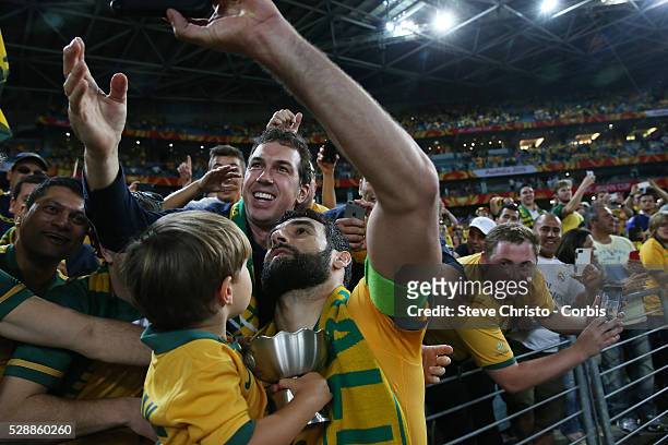 Australia's captain Mile Jedinak takes a selfie during the lap of honour after beating Korea Republic 2-1 at Stadium Australia. Sydney Australia....