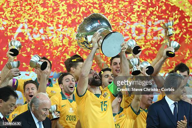 Australia's captain Mile Jedinak holds up the Asia Cup after defeating Korea Republic 2-1 in extra time at Stadium Australia. Sydney Australia....
