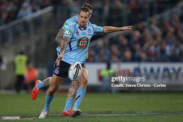 Blue's five-eight Mitchell Pearce kicks ahead against the Maroons during the match at Sydney Olympic Park. Sydney, Australia. Wednesday, 27th May 2015