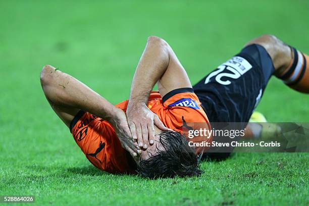 Brisbane Roar's Thomas Broich lies holding his face after being tackled by Wanderers Jerome Polenz at Suncorp Stadium. Brisbane, Australia. Sunday...