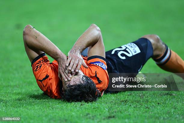 Brisbane Roar's Thomas Broich lies holding his face after being tackled by Wanderers Jerome Polenz at Suncorp Stadium. Brisbane, Australia. Sunday...