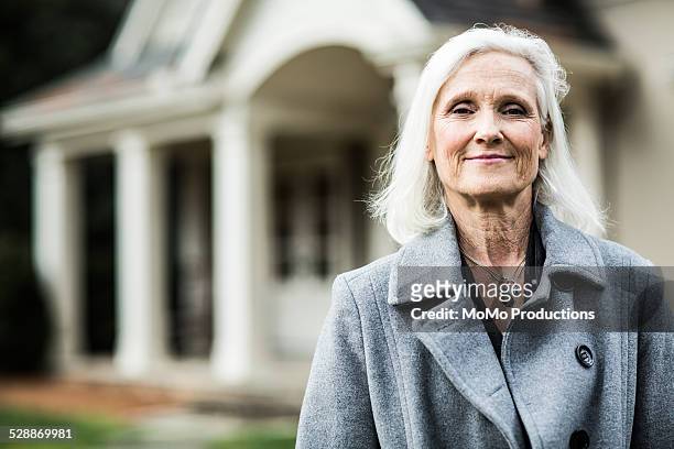portrait of woman in front of home