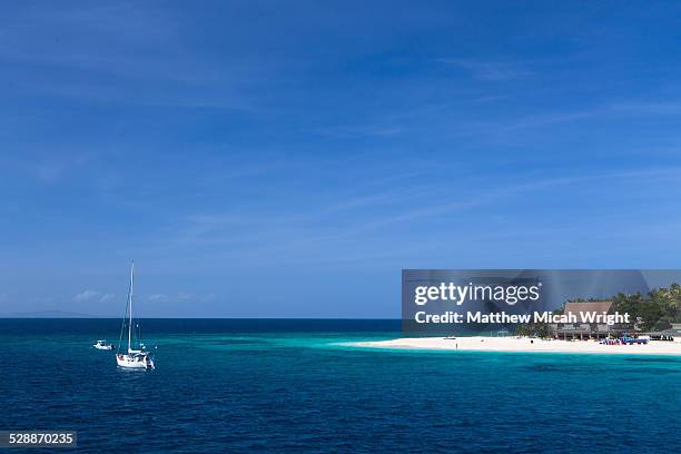 boats head towards beachcomber island, fiji. - beachcomber island stock pictures, royalty-free photos & images