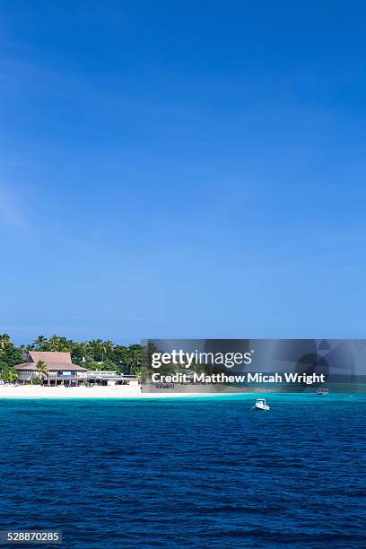 boats head towards beachcomber island, fiji. - beachcomber island stock pictures, royalty-free photos & images