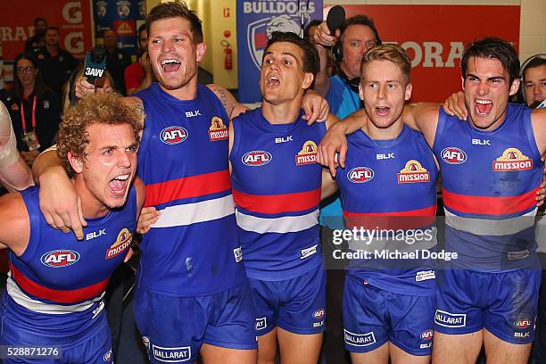 Mitch Wallis Jack Redpath, Jed Adcock, Lachie Hunter and Easton Wood of the Bulldogs sing the club song after winning during the round seven AFL...