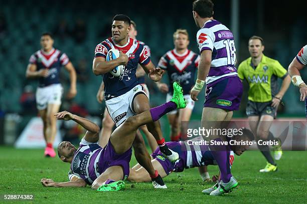 Daniel Tupou of the Roosters runs over Storm's Will Chambers during the Qualifying Final match between Sydney Roosters and Melbourne Storm at Allianz...