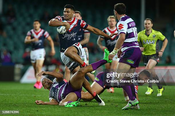 Daniel Tupou of the Roosters runs over Storm's Will Chambers during the Qualifying Final match between Sydney Roosters and Melbourne Storm at Allianz...