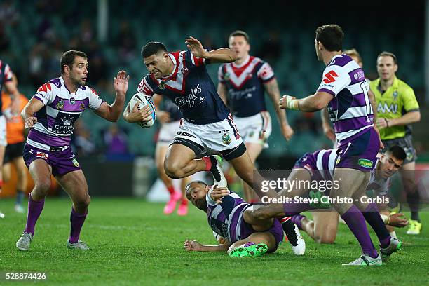 Daniel Tupou of the Roosters runs over Storm's Will Chambers during the Qualifying Final match between Sydney Roosters and Melbourne Storm at Allianz...