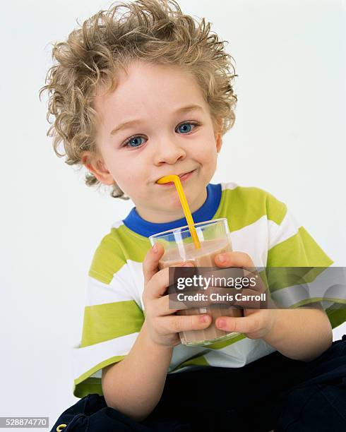 little boy drinking chocolate milk - chocolate milk stock pictures, royalty-free photos & images