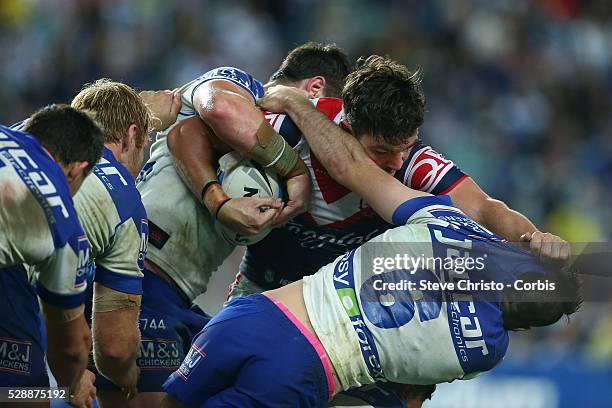 Aidan Guerra of the Roosters fends off Bulldog's Josh Reynolds in this tackle with Josh Jackson during the Semi Final 1 match between the Sydney...