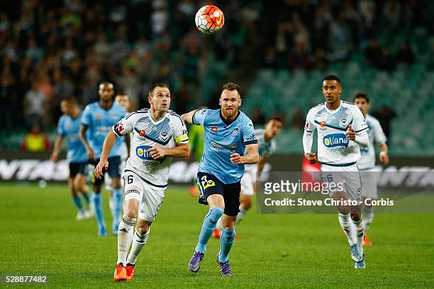 Leigh Broxham of Melbourne Victory clears the ball in front of Sydney FC's Shane Smeltz in the round 6 A-League match between Sydney FC and Melbourne...