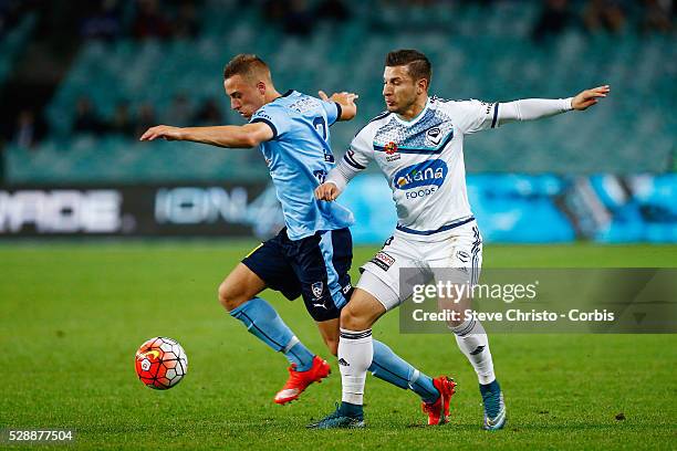 Alexander Gersbach of Sydney FC is challenged for the ball by Melbourne Victory's Kosta Barbarouses in the round 6 A-League match between Sydney FC...