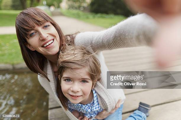 portrait of smiling mother with son outdoors - hazel bond fotografías e imágenes de stock